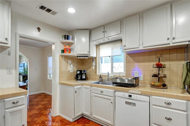 5864 Bonsallo Ave, Los Angeles, CA 90044 - kitchen with dishwasher, tile counters, healthy amount of natural light, white cabinetry, and recessed lighting