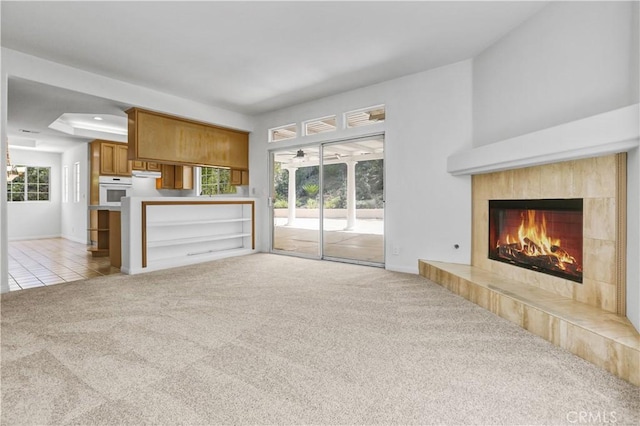 4064 Lemonberry Pl, Thousand Oaks, CA 91362 - unfurnished living room featuring carpet flooring, a tiled fireplace, baseboards, and tile patterned floors