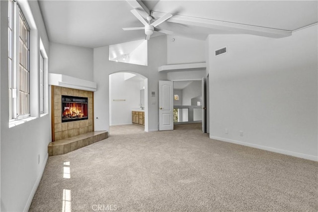4064 Lemonberry Pl, Thousand Oaks, CA 91362 - unfurnished living room featuring ceiling fan, carpet, a fireplace, arched walkways, and baseboards
