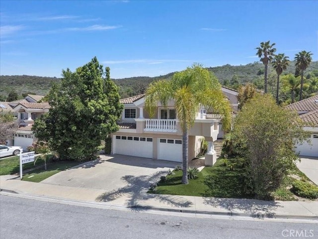 4064 Lemonberry Pl, Thousand Oaks, CA 91362 - obstructed view of property featuring a garage, concrete driveway, a balcony, and a tile roof