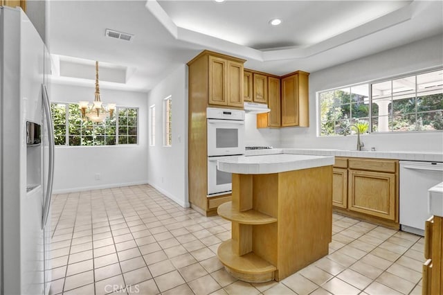 4064 Lemonberry Pl, Thousand Oaks, CA 91362 - kitchen featuring a tray ceiling, white appliances, tile countertops, a chandelier, and open shelves