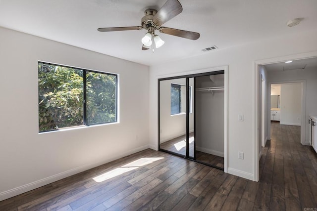 1279 Cypress Dr, Vista, CA 92084 - unfurnished bedroom with dark wood-style flooring, a closet, and ceiling fan