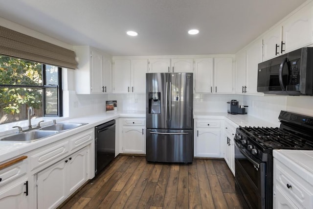 1279 Cypress Dr, Vista, CA 92084 - kitchen with black appliances, white cabinetry, dark wood-style floors, decorative backsplash, and recessed lighting