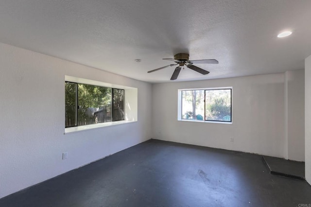 1279 Cypress Dr, Vista, CA 92084 - empty room featuring concrete floors, plenty of natural light, a ceiling fan, a textured ceiling, and recessed lighting