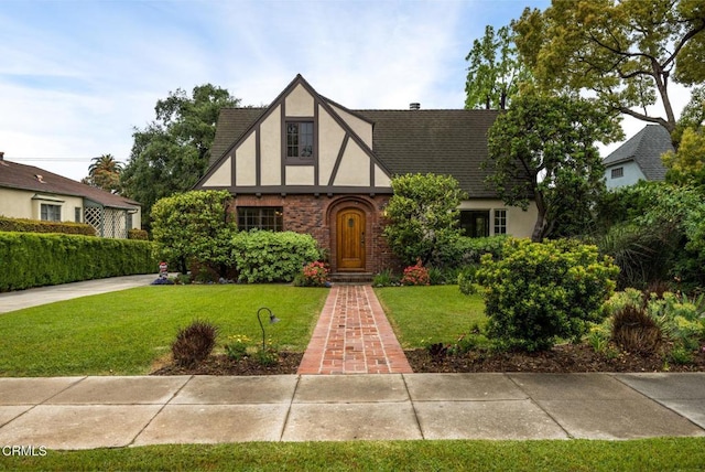 1770 Loma Vista St, Pasadena, CA 91104 - tudor home with stucco siding, a front yard, roof with shingles, and brick siding