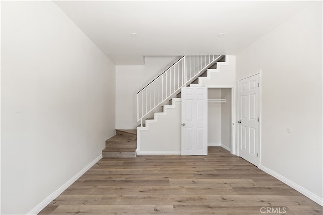 1251 Leighton Ave Unit 1251, Los Angeles, CA 90037 - staircase featuring wood finished floors and baseboards