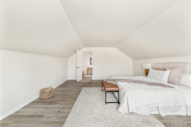 1251 Leighton Ave Unit 1251, Los Angeles, CA 90037 - bedroom featuring wood finished floors, baseboards, and vaulted ceiling
