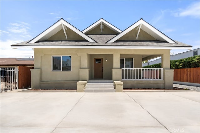 1251 Leighton Ave Unit 1251, Los Angeles, CA 90037 - view of front of property featuring a porch, stucco siding, and a shingled roof