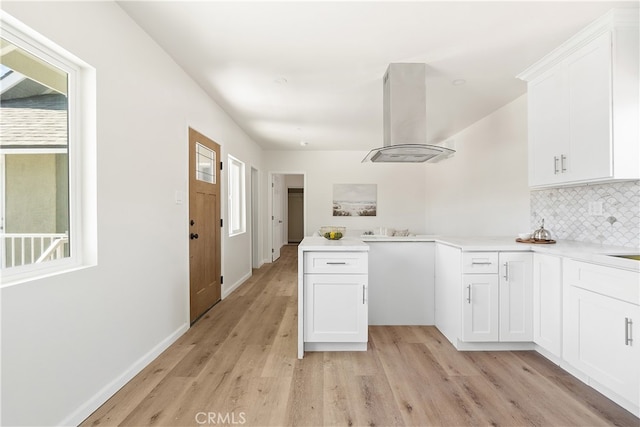1251 Leighton Ave Unit 1251, Los Angeles, CA 90037 - kitchen featuring range hood, a peninsula, light wood-style floors, and backsplash