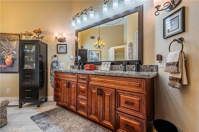 30525 Greenbrook Pl, Canyon Lake, CA 92587 - full bathroom with a chandelier, double vanity, wood finished floors, and baseboards