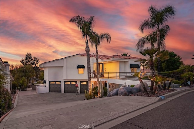 30525 Greenbrook Pl, Canyon Lake, CA 92587 - mediterranean / spanish house featuring stucco siding, an attached garage, driveway, a balcony, and a tile roof