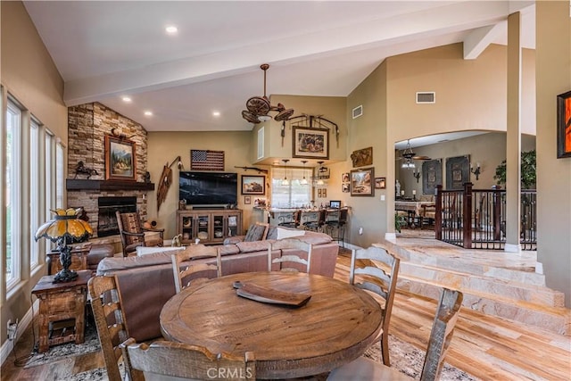 30525 Greenbrook Pl, Canyon Lake, CA 92587 - dining room with a fireplace, beam ceiling, a ceiling fan, wood finished floors, and arched walkways