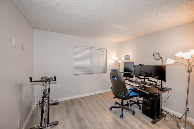 office with wood finished floors, a textured ceiling, and baseboards