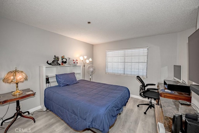 6545 Reseda Blvd Unit 3, Reseda, CA 91335 - bedroom with wood finished floors, a textured ceiling, and an office area