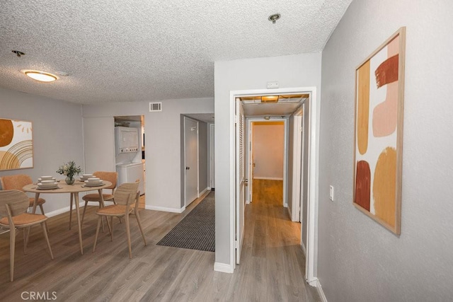 6545 Reseda Blvd Unit 3, Reseda, CA 91335 - corridor featuring light wood-style flooring, a textured ceiling, and stacked washer / drying machine