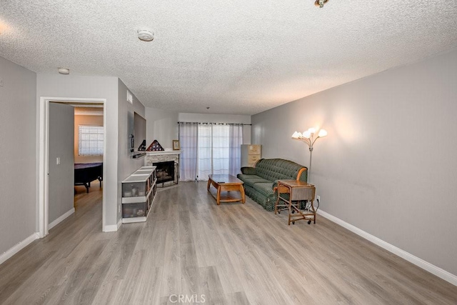 6545 Reseda Blvd Unit 3, Reseda, CA 91335 - living area with plenty of natural light, a textured ceiling, wood finished floors, and a fireplace