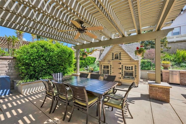 view of patio with a ceiling fan, an outbuilding, a pergola, and outdoor dining area