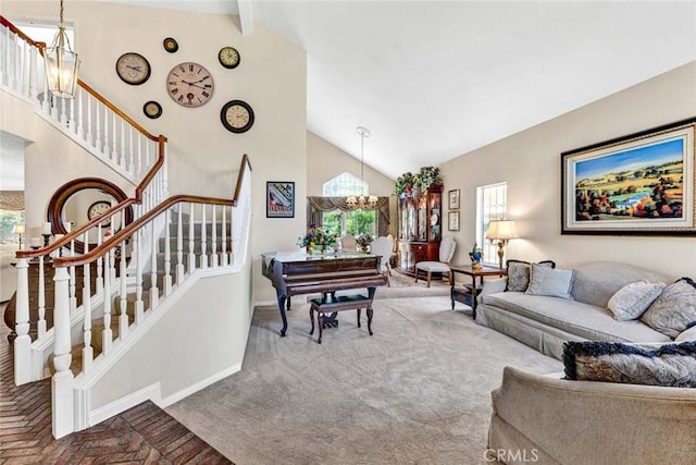 living area with baseboards, stairs, a chandelier, and high vaulted ceiling