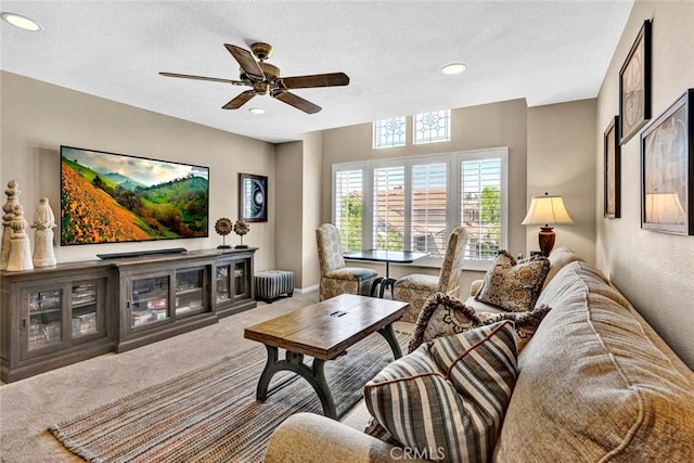 carpeted living room featuring ceiling fan, recessed lighting, and a textured ceiling
