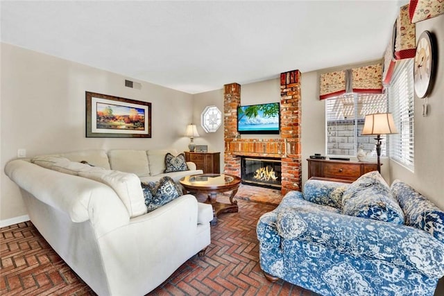 living area with brick flooring, a fireplace, and baseboards