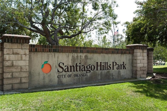community / neighborhood sign with a yard