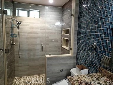 13442 Flower St Unit 15, Garden Grove, CA 92843 - full bath featuring tile walls, vanity, and a stall shower