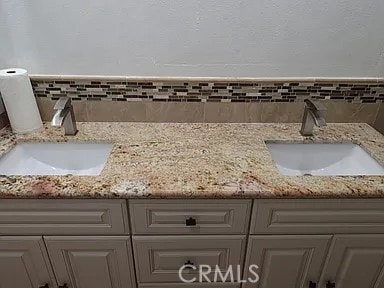 13442 Flower St Unit 15, Garden Grove, CA 92843 - bathroom view of double vanity and decorative backsplash