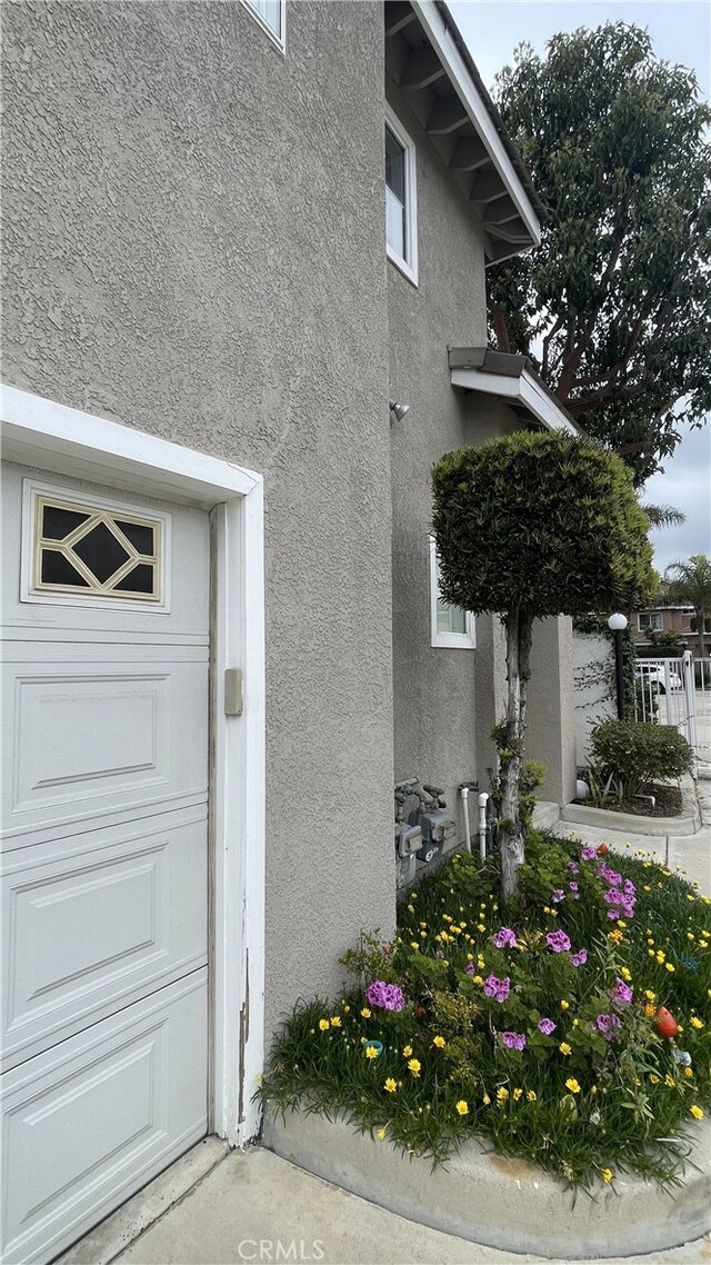 13442 Flower St Unit 15, Garden Grove, CA 92843 - view of side of property featuring stucco siding and a garage