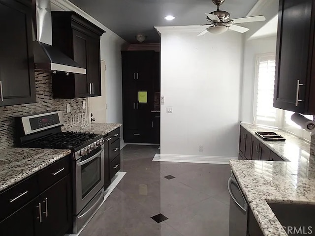 13442 Flower St Unit 15, Garden Grove, CA 92843 - kitchen with stainless steel appliances, wall chimney range hood, tasteful backsplash, ceiling fan, and light stone countertops