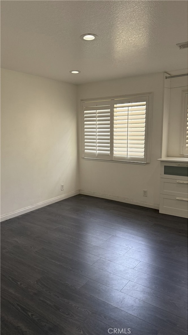 13442 Flower St Unit 15, Garden Grove, CA 92843 - spare room with dark wood-style flooring, plenty of natural light, a textured ceiling, and recessed lighting