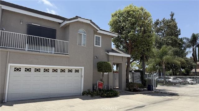 13442 Flower St Unit 15, Garden Grove, CA 92843 - view of front of house featuring concrete driveway, stucco siding, and a garage