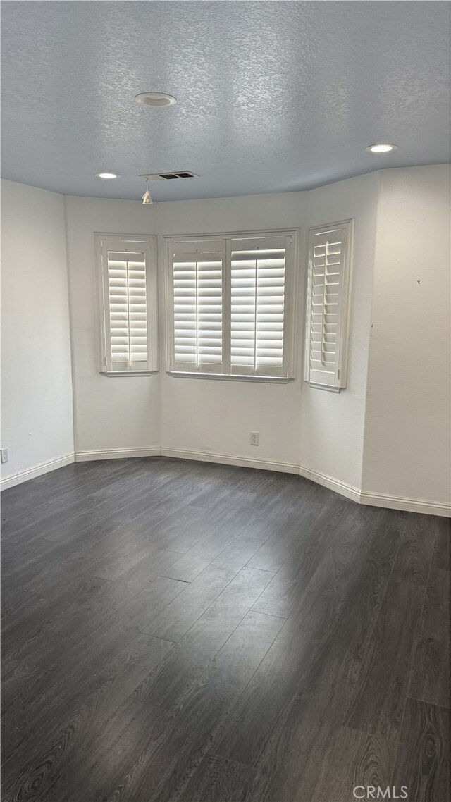 13442 Flower St Unit 15, Garden Grove, CA 92843 - empty room with dark wood-style flooring and a textured ceiling