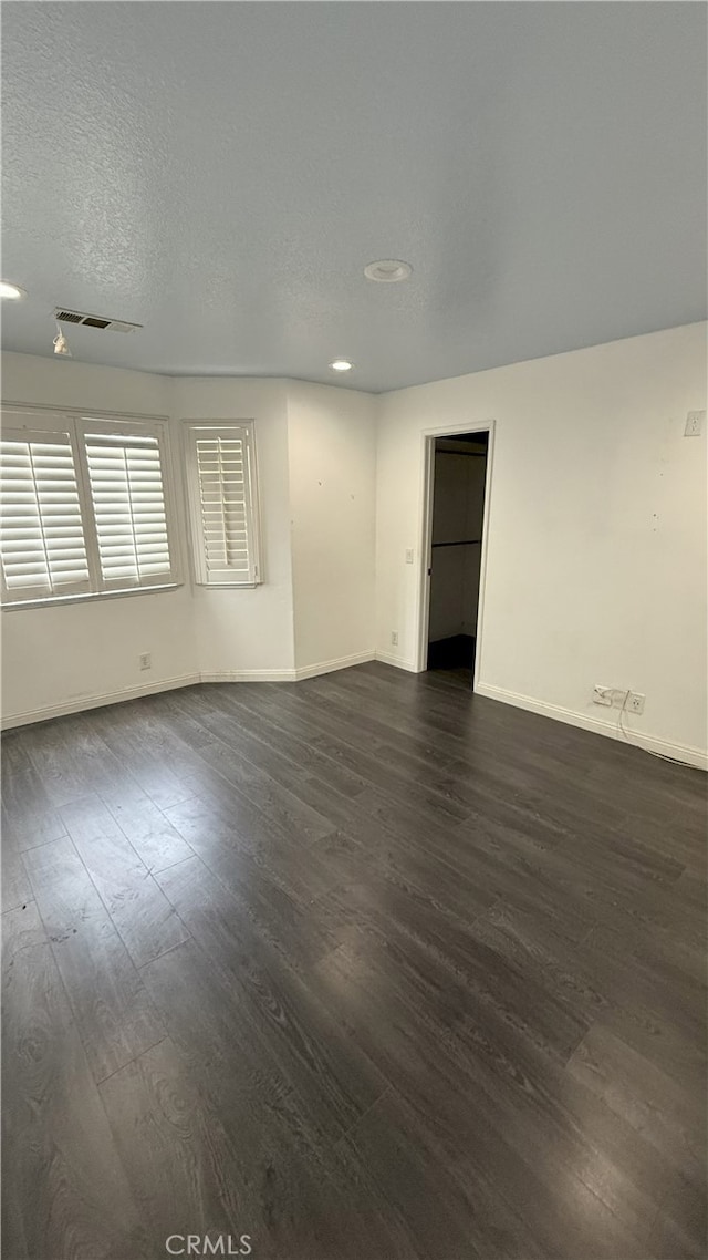 13442 Flower St Unit 15, Garden Grove, CA 92843 - spare room featuring dark wood-type flooring, recessed lighting, and a textured ceiling