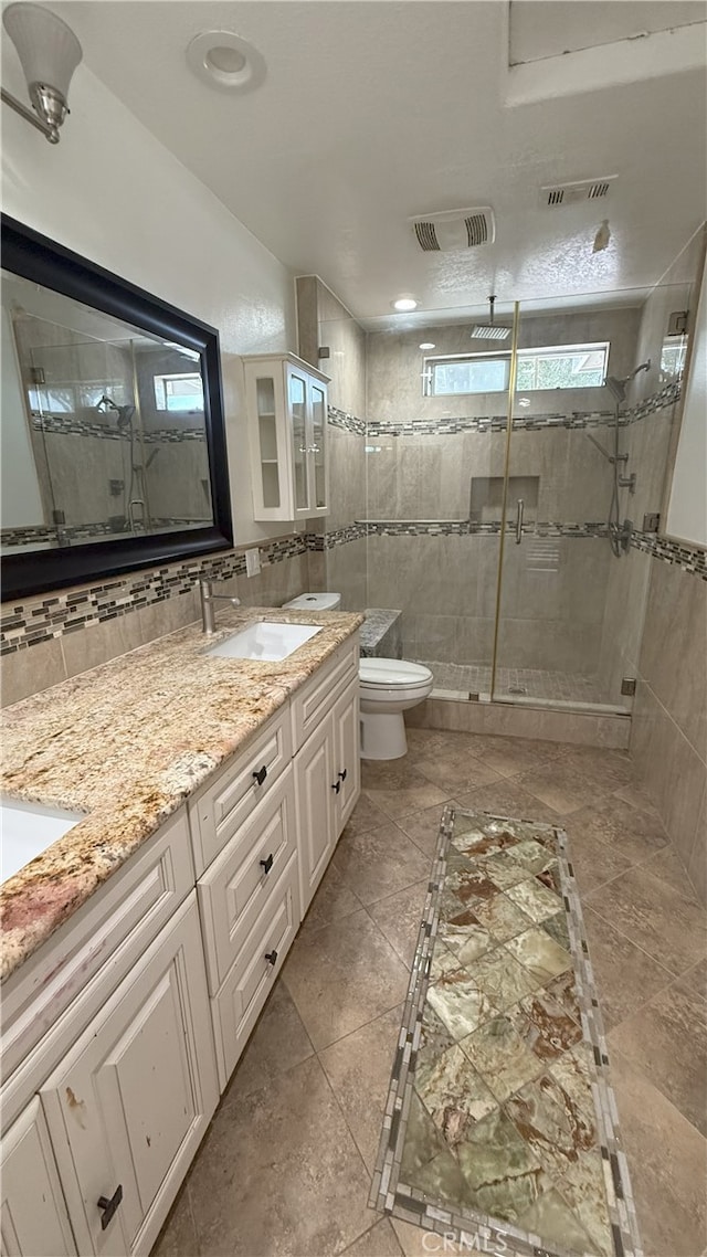 13442 Flower St Unit 15, Garden Grove, CA 92843 - full bath featuring a shower stall, double vanity, and tile walls