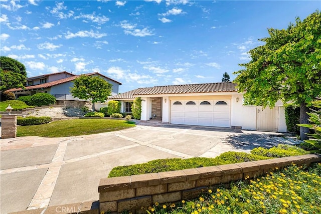 24752 Via, San Anselmo, Mission Viejo, CA 92692 - view of front of property with a tile roof, driveway, a garage, and stucco siding