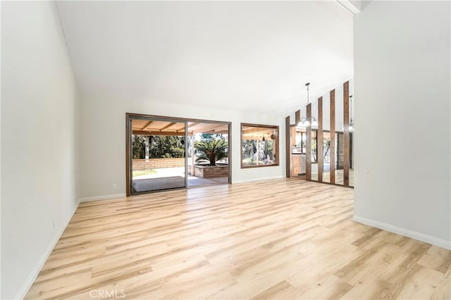 24752 Via, San Anselmo, Mission Viejo, CA 92692 - empty room with wood finished floors, baseboards, and vaulted ceiling