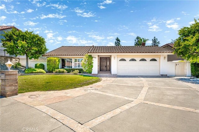 24752 Via, San Anselmo, Mission Viejo, CA 92692 - view of front facade with a tiled roof, a chimney, concrete driveway, a front yard, and a garage