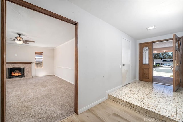 24752 Via, San Anselmo, Mission Viejo, CA 92692 - foyer with healthy amount of natural light, a fireplace, baseboards, ceiling fan, and crown molding