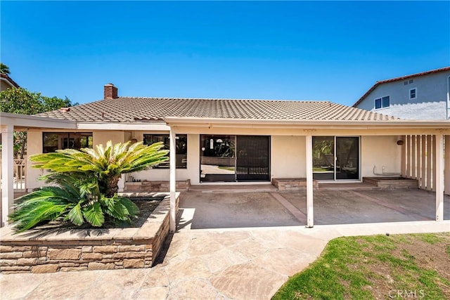 24752 Via, San Anselmo, Mission Viejo, CA 92692 - back of house featuring a chimney, a patio, stucco siding, and a tile roof