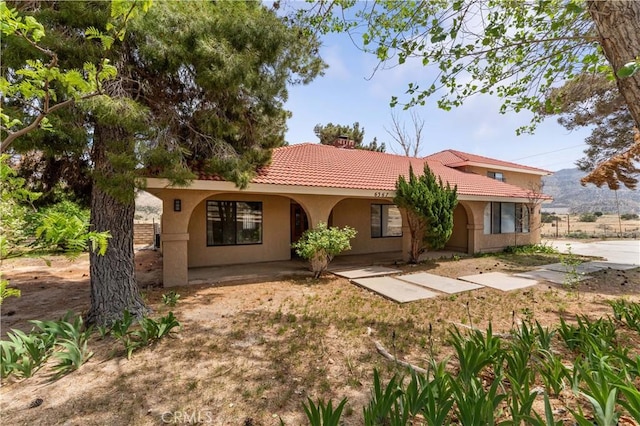 6367 Arrowhead Lake Rd, Hesperia, CA 92345 - mediterranean / spanish-style home with a tile roof, stucco siding, and a chimney