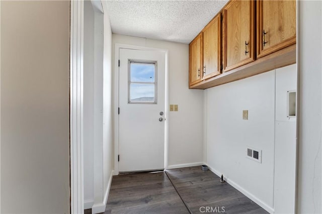 6367 Arrowhead Lake Rd, Hesperia, CA 92345 - laundry room featuring dark wood-style flooring, a textured ceiling, and cabinet space