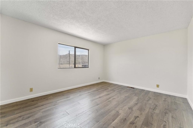 6367 Arrowhead Lake Rd, Hesperia, CA 92345 - empty room featuring wood finished floors and a textured ceiling