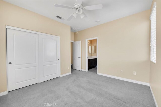 8 Via Del Fico Ct, Lake Elsinore, CA 92532 - unfurnished bedroom with light carpet, baseboards, a closet, ensuite bathroom, and a ceiling fan
