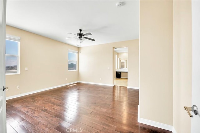 8 Via Del Fico Ct, Lake Elsinore, CA 92532 - empty room featuring plenty of natural light, dark wood-type flooring, a smoke detector, and a ceiling fan