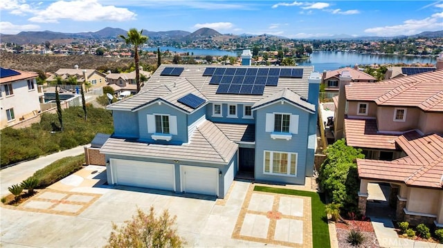 8 Via Del Fico Ct, Lake Elsinore, CA 92532 - traditional-style house featuring a garage, driveway, a residential view, solar panels, and a tiled roof