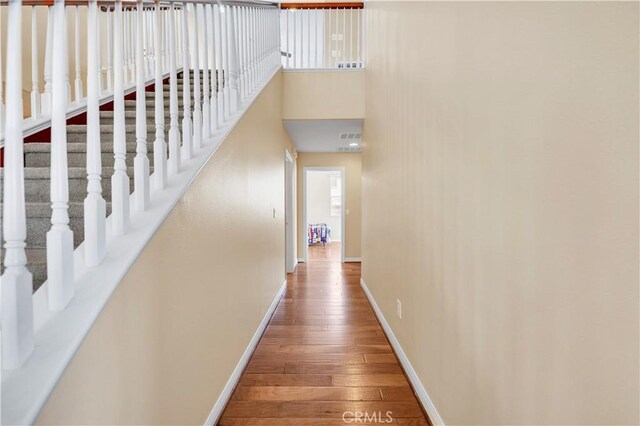 8 Via Del Fico Ct, Lake Elsinore, CA 92532 - hallway featuring baseboards, hardwood / wood-style flooring, and a towering ceiling