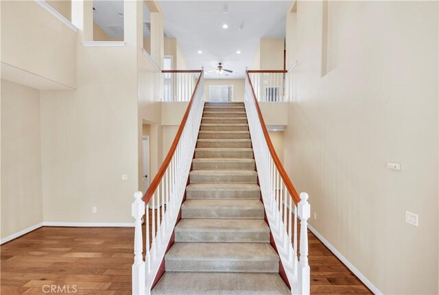 8 Via Del Fico Ct, Lake Elsinore, CA 92532 - staircase with ceiling fan, wood finished floors, a towering ceiling, recessed lighting, and baseboards
