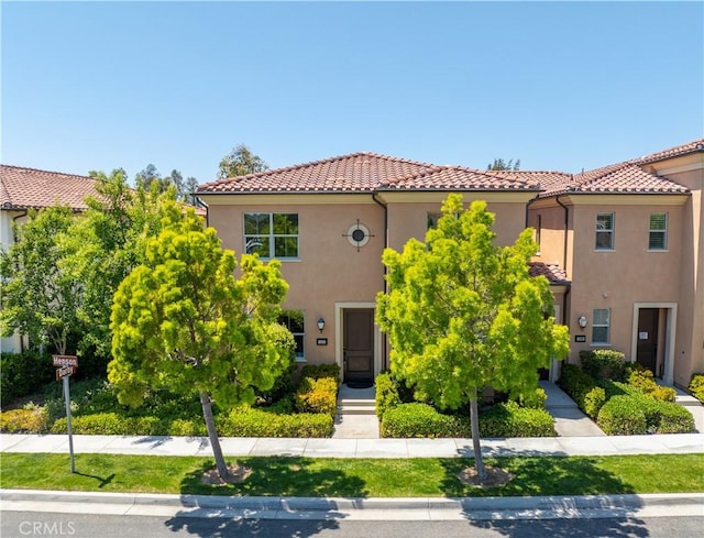 mediterranean / spanish-style home featuring stucco siding and a tiled roof