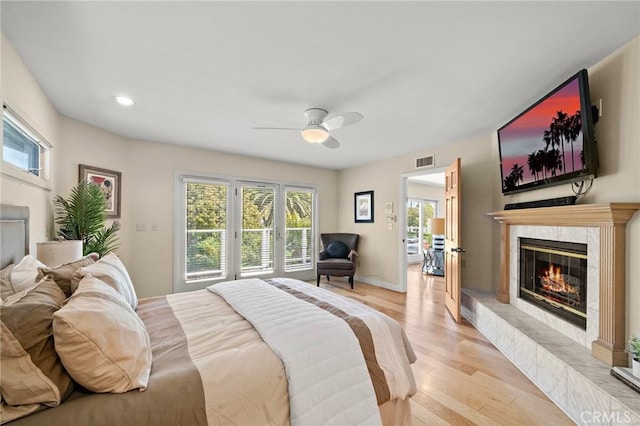 5894 E Appian Way, Long Beach, CA 90803 - bedroom featuring a high end fireplace, light wood-style flooring, recessed lighting, a ceiling fan, and baseboards