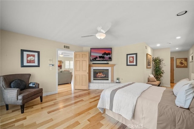 5894 E Appian Way, Long Beach, CA 90803 - bedroom with light wood-style floors, a tile fireplace, recessed lighting, and baseboards